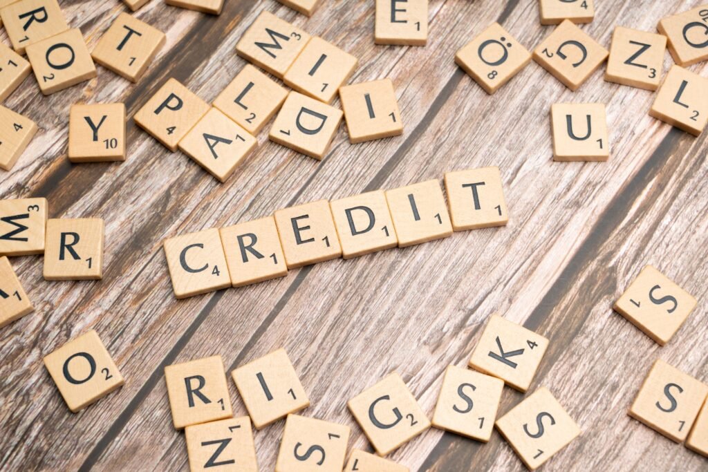 FICO 10T vs VantageScore 4.0: What the New Credit Models Mean for Your 2026 Mortgage Wooden letter tiles arranged to spell 'CREDIT' on a rustic table background.