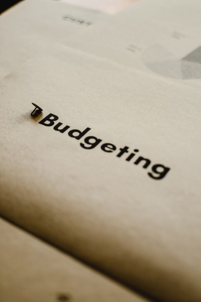 The 50/30/20 Budget Rule: How to Build a 5-Line Budget in 12 Minutes (With Houston Cost Examples) Close-up of budgeting concept on paper with focus on typography and abstract elements.