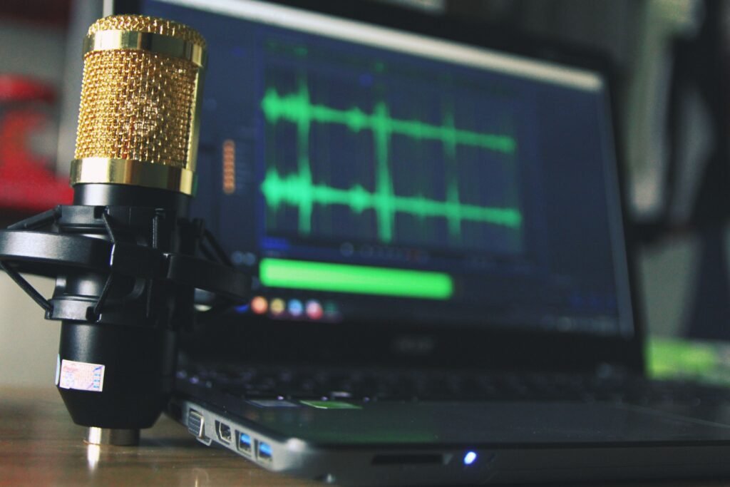 ElevenLabs v1 Models Retire July 9, 2026: What Faceless Creators Should Do This Week Close-up of a golden microphone and laptop used for audio editing.